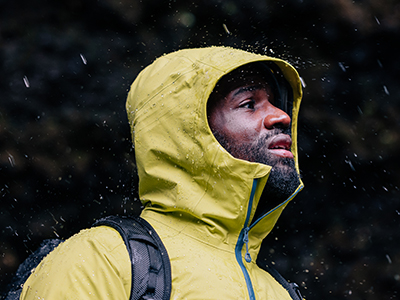 close up of man wearing waterproof coat with hood up